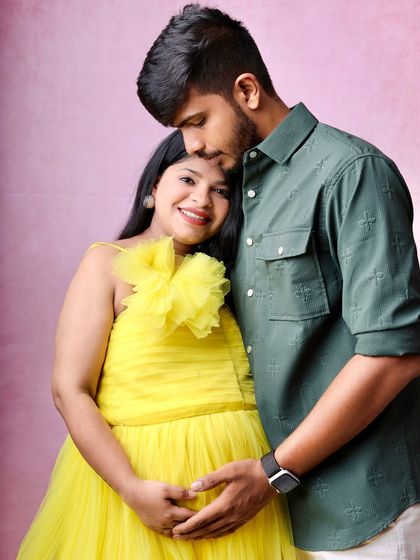 A quiet, intimate portrait of the couple. The focus is on their gentle embrace and the shared joy of waiting for their baby.