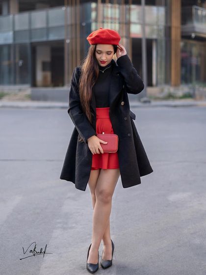 A candid-style moment from the Parisian theme. The model adjusts her beret, creating a natural and stylish portrait that captures the essence of effortless French fashion.