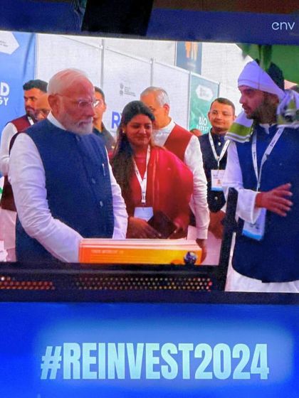 Another view of our founder explaining the features of the Smart Solar Hut to Honorable Prime Minister Shri Narendra Modi. His engagement and questions about our project's employment impact were deeply motivating.