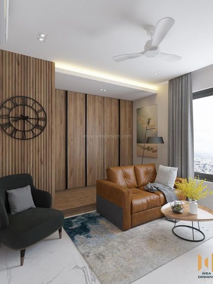 A wider view of the TATA Promont room, showing the comfortable L-shaped sofa and accent chair.