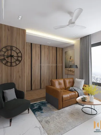 A wider view of the TATA Promont room, showing the comfortable L-shaped sofa and accent chair.