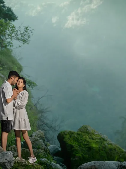 Standing together amidst the misty, green landscape by the river. This shot captures the quiet, peaceful atmosphere of the Rishikesh mountains and the couple's serene connection.