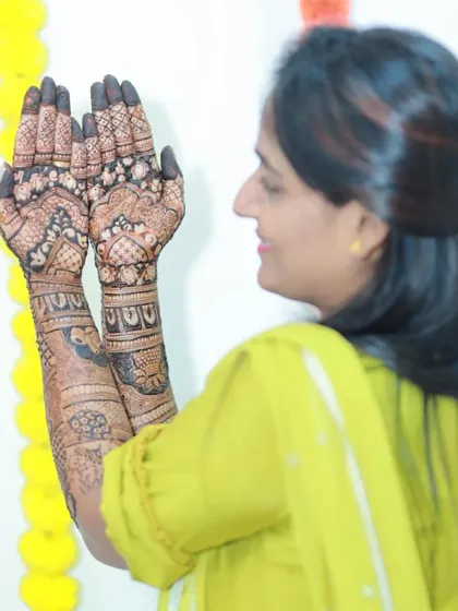 A side view of the bride, showing off her palms. The intricate patterns are a work of art.