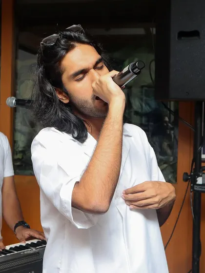 A shot of our vocalist Aryaman in his element during a live gig. The focus and passion are real, whether it's a big stage or an intimate club.