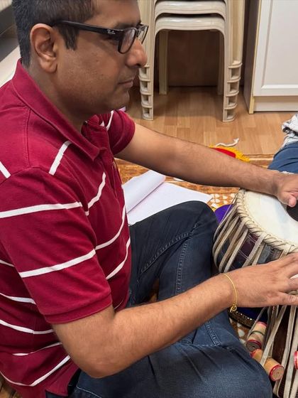 An adult student practices the tabla, demonstrating that the passion for learning this classical instrument is not limited by age. Our classes welcome everyone.