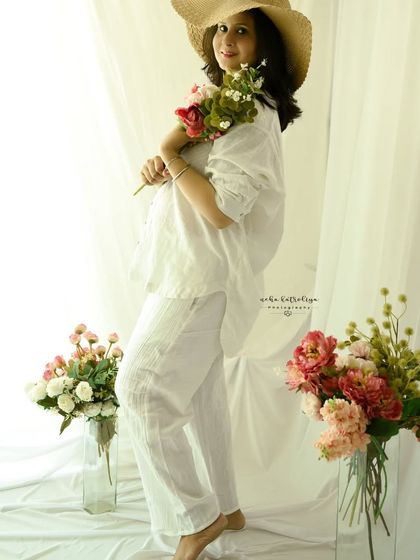 Playing with props like a straw hat and flowers can add a soft, summery feel to a studio session.