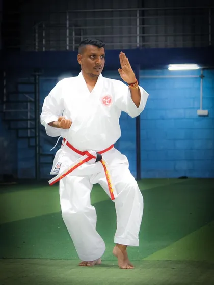As the head instructor, I demonstrate the core principles of Okinawa Shorin Ryu Karate. Here, I am in a classic Shuto Uke (knife-hand block) stance, a fundamental technique that embodies both defense and readiness.