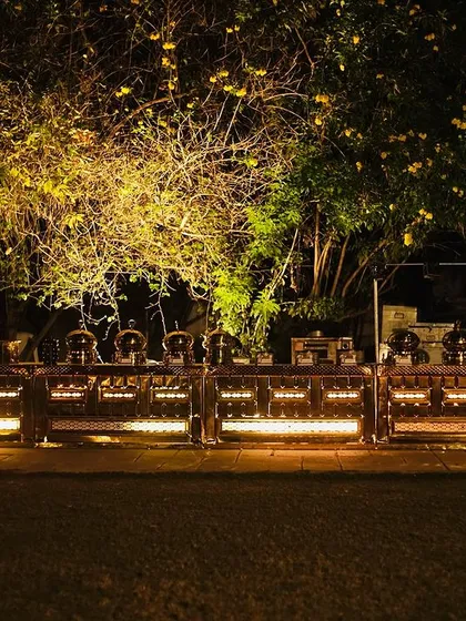 This is how I transform an outdoor space into an elegant dining experience. This beautifully lit buffet setup at a night event shows my commitment to creating an atmosphere that is as delightful as the food itself.
