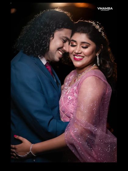 An intimate embrace at the reception. We use creative lighting to highlight the couple's connection and create a beautiful, romantic portrait.