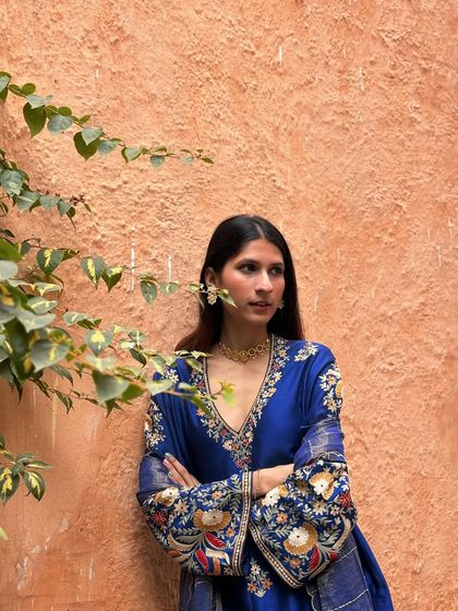 Another portrait in the blue kurta set, showcasing its rich color and luxurious feel. It's a look that is both traditional and incredibly chic.
