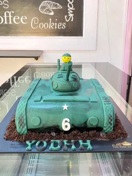 A custom army tank cake for a 6th birthday. This sculpted cake is perfect for a child who loves military vehicles and action-packed themes.