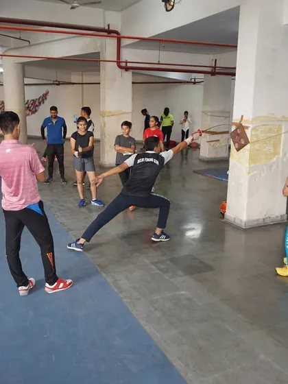 A fencer demonstrates a full-body extension during a lunge, a key component of effective target practice and competitive fencing.