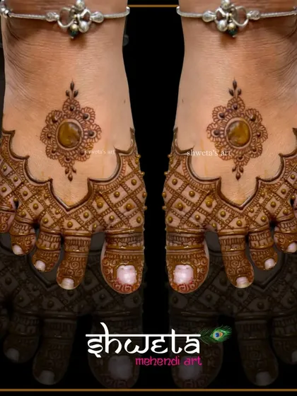 This stylish leg design features a central jewel-like motif surrounded by intricate jaali work. It gives the appearance of wearing an ornament on your feet.