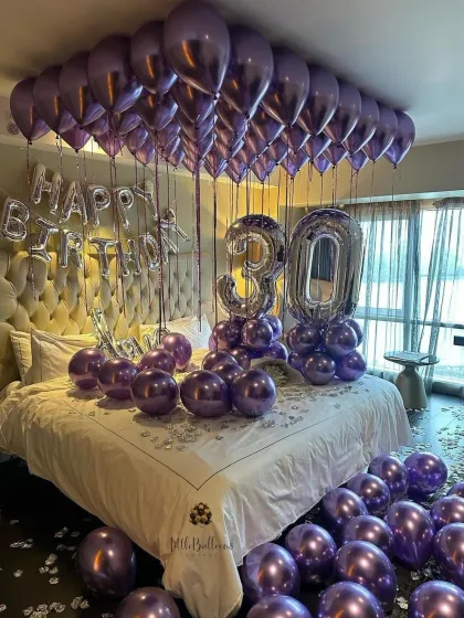 A stylish and sophisticated room decoration for a 30th birthday. We used a chic color palette of chrome purple and silver balloons, with large foil numbers to mark the milestone.