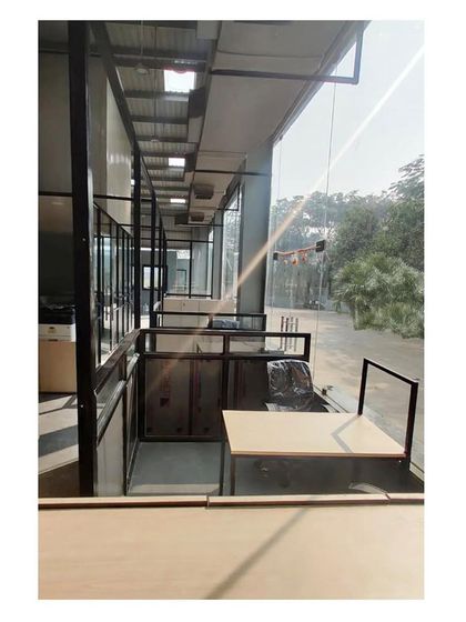 An in-progress shot of the office workstations being installed. The design uses a mezzanine level to maximize the usable floor area within the high-ceilinged warehouse structure.