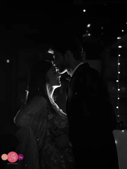 A tender forehead kiss, captured in a dramatic black and white silhouette. We use light and shadow to create artistic, emotionally powerful portraits.