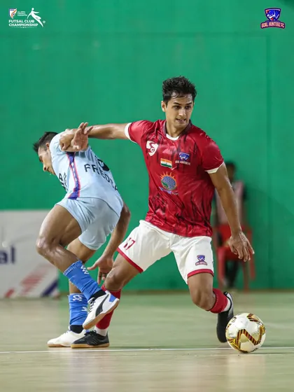 A player shielding the ball from a defender during the quarter-final.
