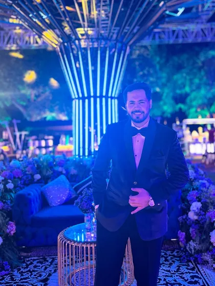 A happy, relaxed photo in front of the beautiful floral and light decor. I always take a moment to appreciate the beautiful settings.