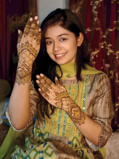 A young and happy client with her party mehndi. The design is simple, elegant, and perfect for her.