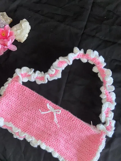 The heart shape the strap makes is so cute! This shows the full design of the coquette-style ruffle bag, which you can get in custom colors.