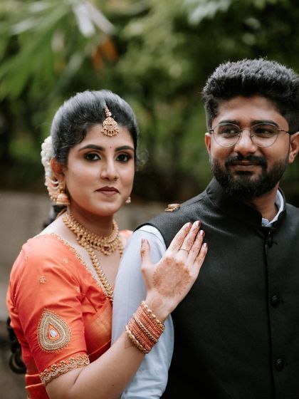 A classic couple portrait with the bride gently resting her hand on the groom's shoulder. It's a simple, timeless pose that speaks volumes about their bond.
