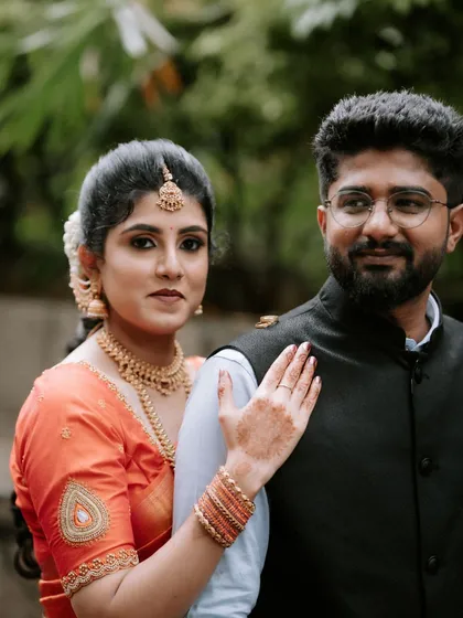 A classic couple portrait with the bride gently resting her hand on the groom's shoulder. It's a simple, timeless pose that speaks volumes about their bond.