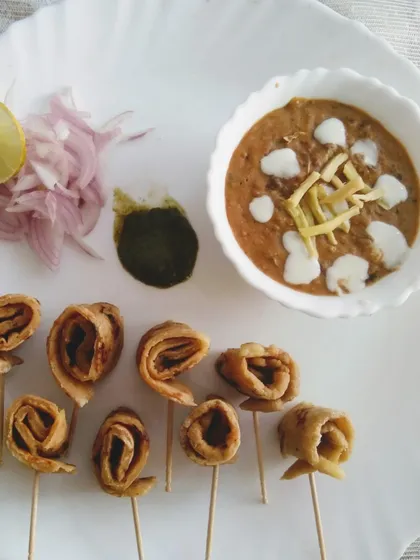 A creative presentation of a comforting meal. Here, I've served a rich, creamy dal alongside whole wheat roti pinwheels, perfect for dipping. It’s a fun twist on the classic dal-roti.