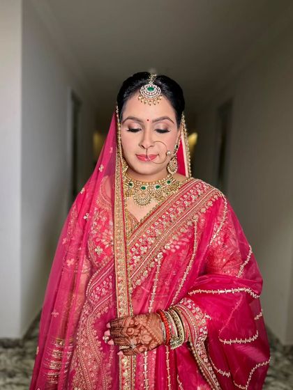 A serene moment captured. The soft, shimmery eyeshadow and perfectly blended base create a flawless canvas, letting the bride's natural beauty take center stage.