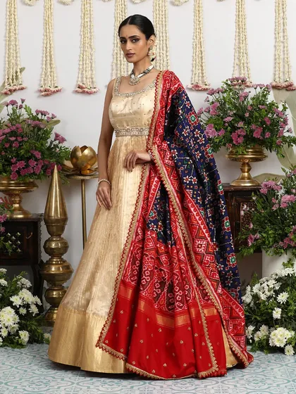 The full, flowing silhouette of the gold gown is perfect for making a grand entrance at any celebration.