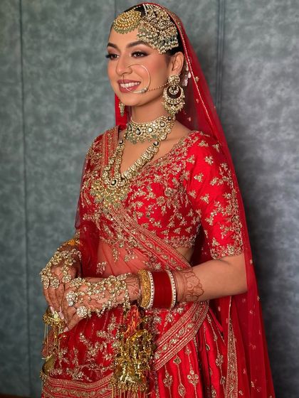 Red isn't just a color; it's an aura. This look is all about attitude and allure, with a sharp eye and glowing skin to match the vibrant red lehenga.