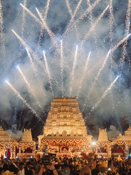 The backdrop for this varmala was a magnificent temple replica, and I used a massive fireworks display to frame the entire scene. This wide shot shows the sheer scale and grandeur of the moment.