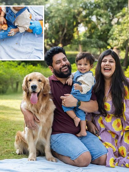 The whole family laughing together during Aariv's first birthday cake smash. Ollie the Golden Retriever is right there with them, tongue out and ready for fun. A perfect, joyful family portrait.