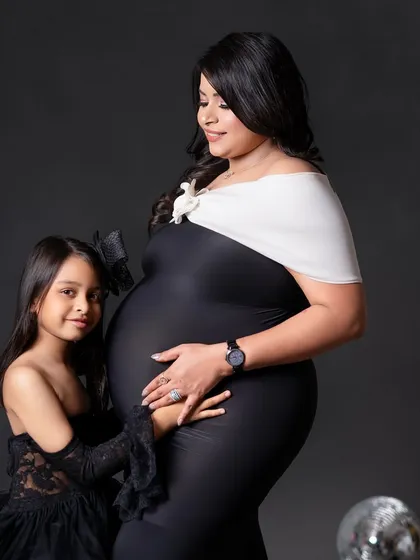 A sweet moment between mom and her daughter, who is about to become a big sister. Her hand on the baby bump is just precious.