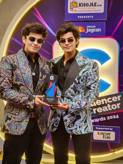 Here, the contrast between the two colorways of the printed jacket is visible. One features cooler blue and grey tones, while the other incorporates warmer purples, showing the versatility of a single design concept.