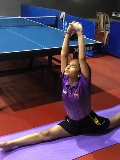 A player demonstrating incredible flexibility during a yoga session. This level of flexibility helps in executing dynamic shots and improves reach on the table.