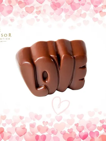 Say it with chocolate. This solid milk chocolate piece is molded into the word "LOVE," making it a simple and sweet gift for Valentine's Day or an anniversary.