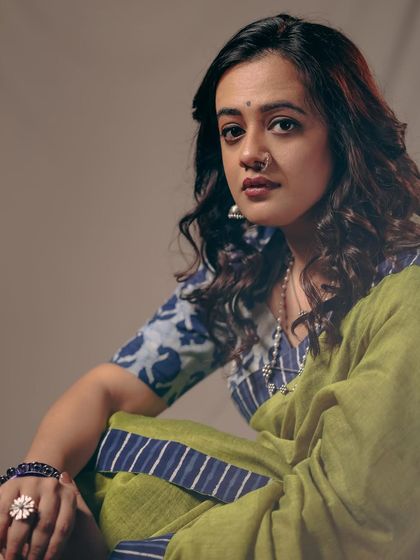 An intense and captivating portrait of Spruha Varad. The styling, with a printed blouse and oxidized jewelry, adds depth to her expressive look.