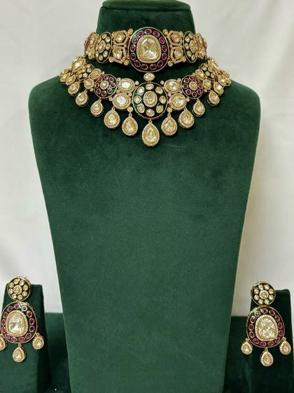 A two-piece necklace set for rent, featuring a choker and a matching guluband necklace. The red Meenakari work adds a touch of traditional colour.