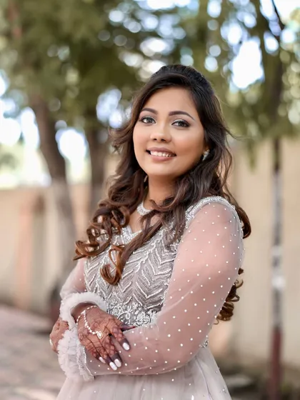 A happy portrait of the bride, showcasing her beautiful smile and sparkling reception makeup.