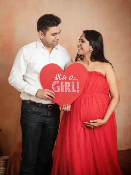 A fun way to share your big news. I have props like this "It's a Girl!" sign to help you announce the gender of your baby during your couple's maternity shoot.