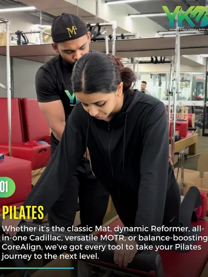 We have every tool to take your Pilates journey to the next level. This image shows a client receiving personalized instruction on the Cadillac, a versatile piece of equipment for all-in-one training.