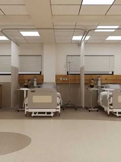 Even in a multi-bed ward, we create a sense of personal space. This image shows how we use subtle design elements, like designated floor patterns and thoughtfully placed artwork, to define each patient's area and add a touch of warmth.
