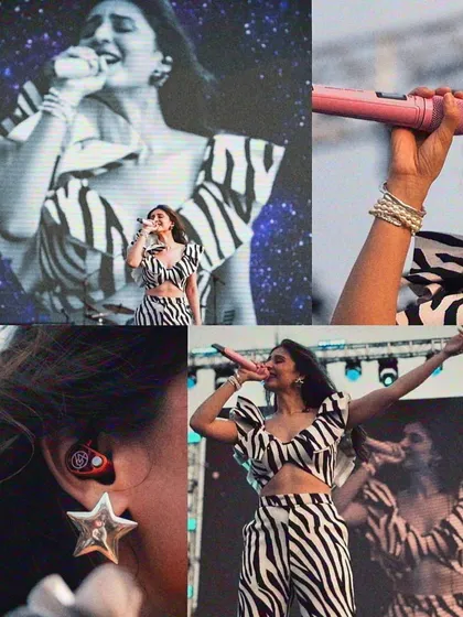It's all in the details. This collage shows close-ups of Dhvani Bhanushali's zebra print stage outfit, from the star-shaped earring to the ruffled top and stacked bracelets.
