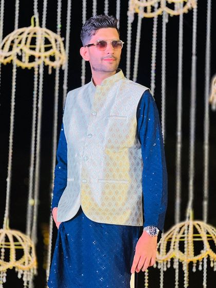 Dressed in a stylish Nehru jacket against a beautiful backdrop. My attire is always carefully chosen to match the event's theme and grandeur.
