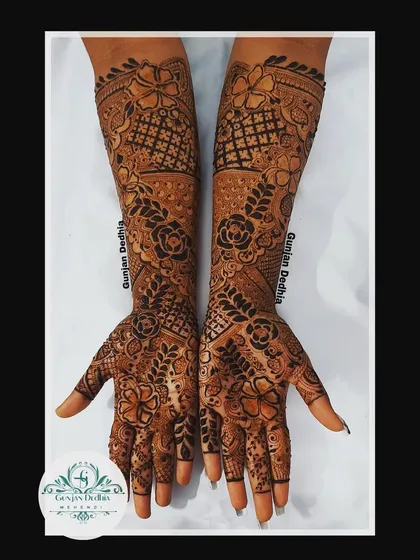 A custom full-hand floral design. The pattern is dense with flowers and leaves, creating a lush, garden-like effect that is perfect for any celebration.