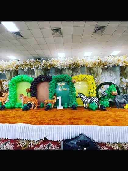 This grand-scale jungle theme fills an entire stage. Multiple balloon arches in different colors represent different parts of the jungle, creating an immersive environment for guests.