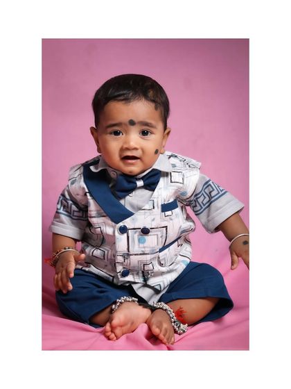 A classic seated portrait of a baby boy in his formal outfit. Even when they are a little unsure, I work to capture their genuine expressions during the shoot.