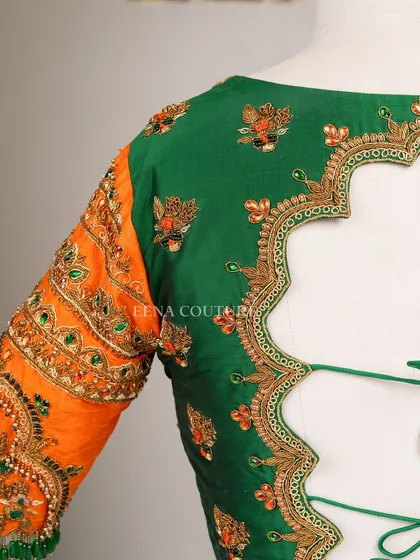 This blouse is a celebration of vibrant color and artistry. I used a rich green raw silk base and contrasted it with bright orange sleeves, which feature incredibly detailed peacock embroidery using zardozi, stones, and beadwork.