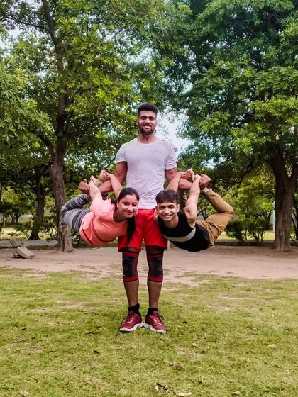Another creative three person acro yoga pose. We love experimenting with different shapes and balances in the park. It’s a practice that combines strength, flexibility, and friendship.