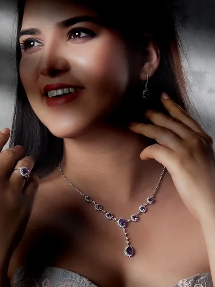 Radiant elegance from every angle. This gemstone necklace set, with its matching earrings and ring, is designed for life's grandest occasions. The deep purple gems are surrounded by diamonds, creating a look of pure sophistication and glamour.